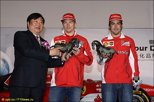 Сюйгуан Тан вручает подарки гонщикам Ferrari 
