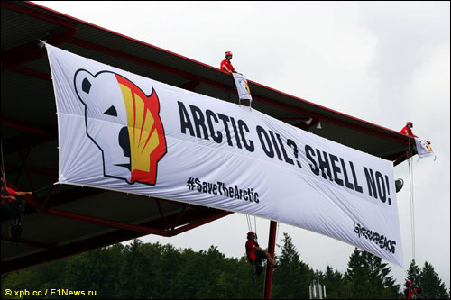 Активисты Greenpeace вешают баннер на главной трибуне Спа