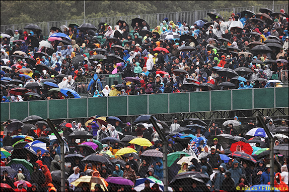 Пошёл дождь, на заполненных болельщиками трибунах появились плащи и зонтики